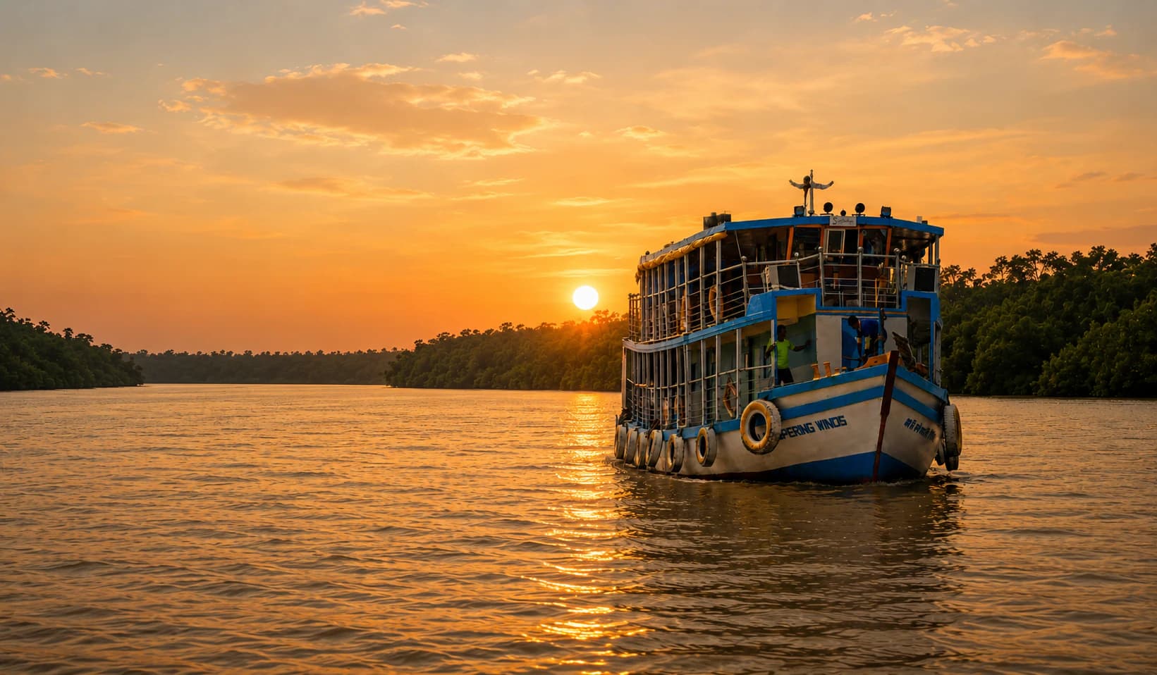 Whispering Winds travelling through the Sundarban waterways at sunset