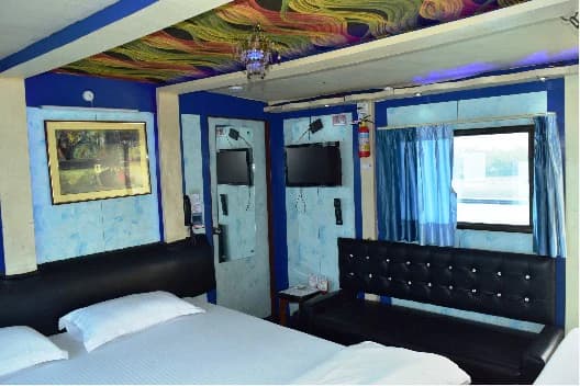 Alternate cabin layout aboard Whispering Winds with bed, seating and television